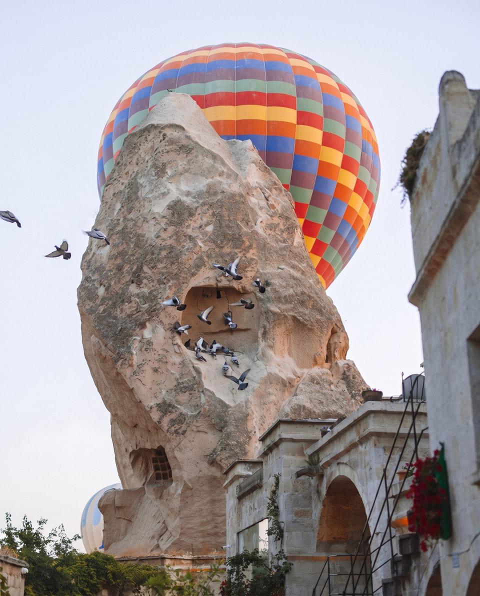 Pigeons and a balloon above the fairy chimney