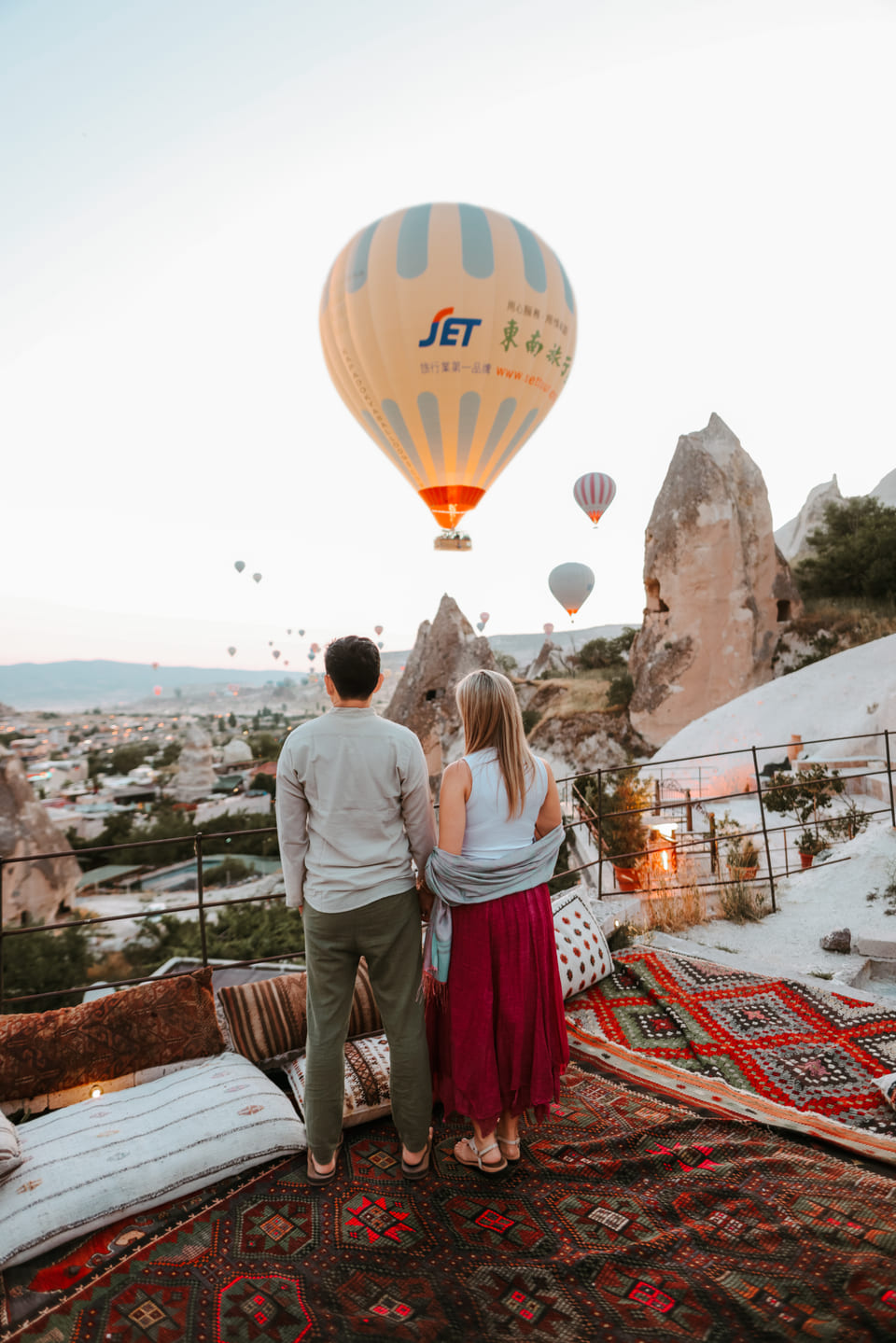 Two guests on the terrace as the balloons pass